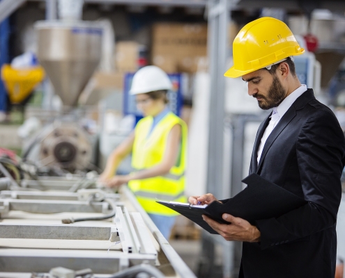 Young quality inspector checking production line